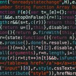 Close-up of colorful coding text on a dark computer screen, representing software development.